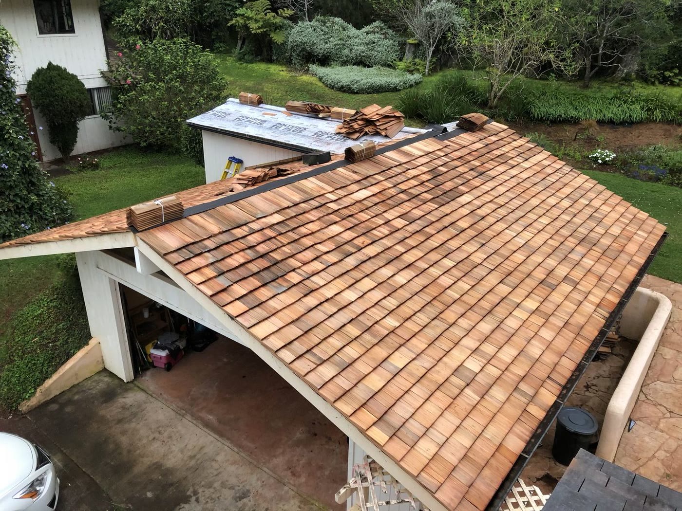 Cedar shake roof mid-installation, viewed from above